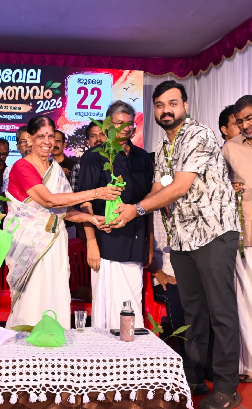 Njattuvela Mahotsavam 2026 closing day — receiving a sapling from Prof. Savithri Lakshmanan